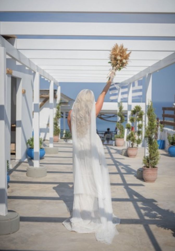 Bride holding her bouquet in the air